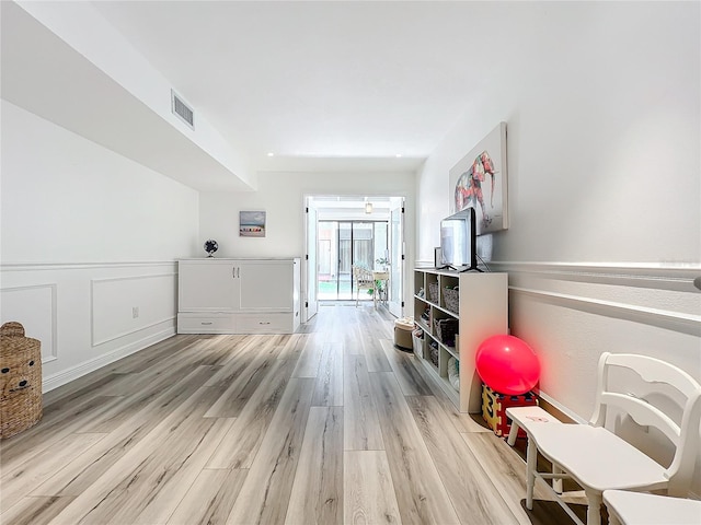 game room with light hardwood / wood-style flooring