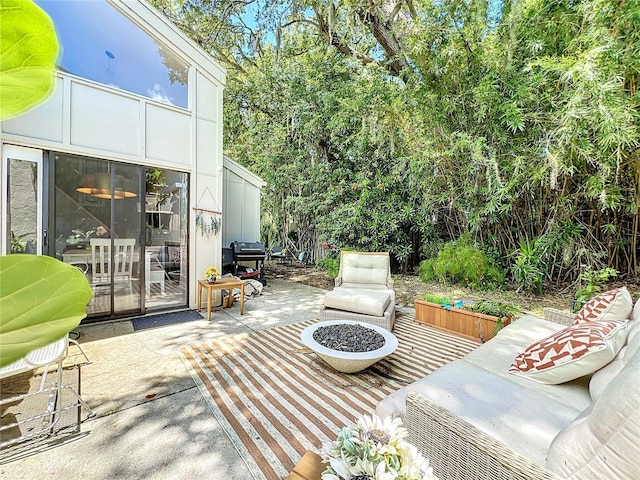 view of patio featuring an outdoor living space with a fire pit