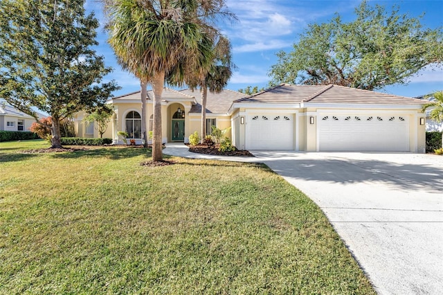 view of front of home with a front yard and a garage