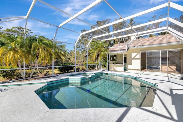 view of pool with a lanai, a patio area, and an in ground hot tub