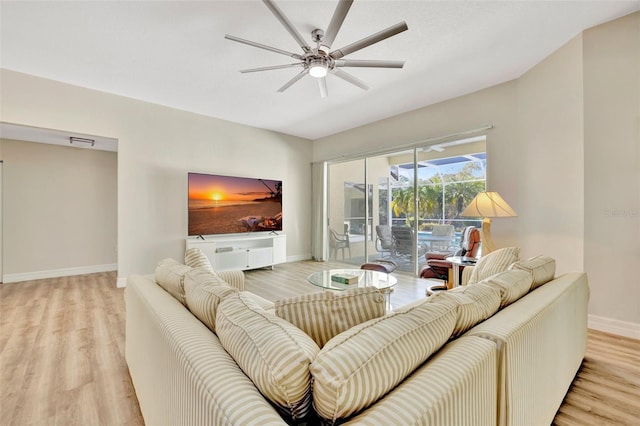 living room with light hardwood / wood-style flooring and ceiling fan