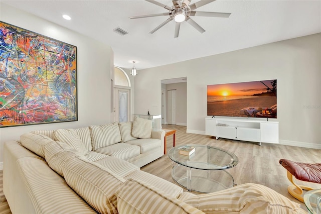 living room with light hardwood / wood-style floors and ceiling fan