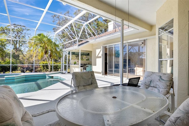 view of swimming pool featuring glass enclosure and a patio area