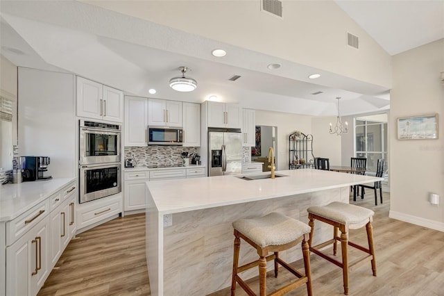 kitchen with sink, white cabinets, and appliances with stainless steel finishes