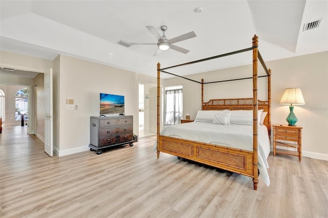 bedroom featuring light wood-type flooring, multiple windows, and ceiling fan