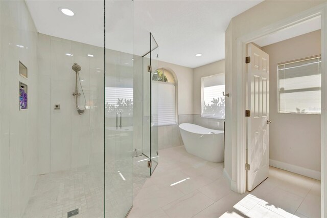 bathroom featuring tile patterned floors and shower with separate bathtub