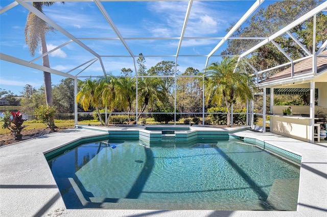 view of swimming pool with an in ground hot tub, a patio area, and a lanai