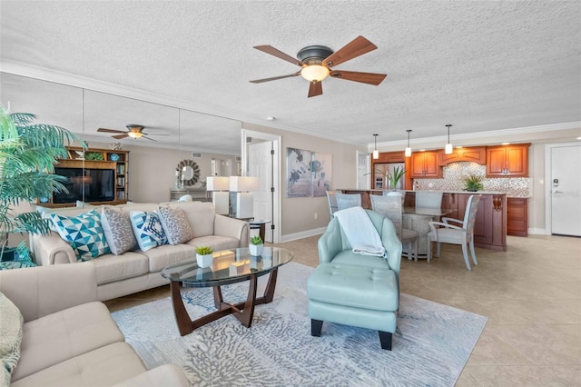 tiled living room with a textured ceiling, ceiling fan, and crown molding