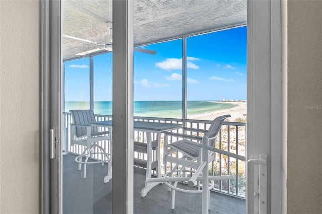 interior space featuring a water view and a view of the beach