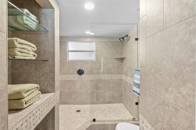 bathroom with toilet and tiled shower