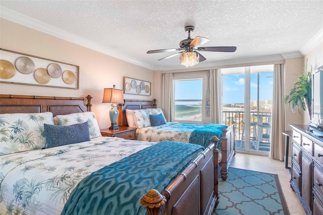 tiled bedroom with access to exterior, a textured ceiling, ceiling fan, and ornamental molding