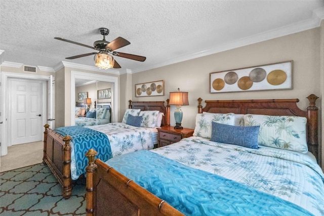 bedroom with ceiling fan, ornamental molding, a textured ceiling, carpet floors, and a closet