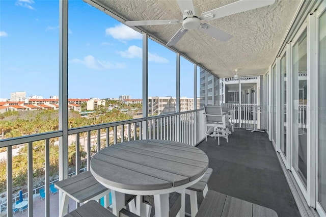 sunroom / solarium featuring ceiling fan