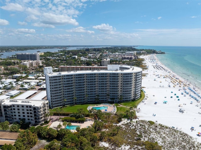 bird's eye view with a water view and a beach view