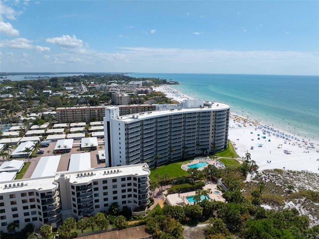 drone / aerial view with a water view and a beach view