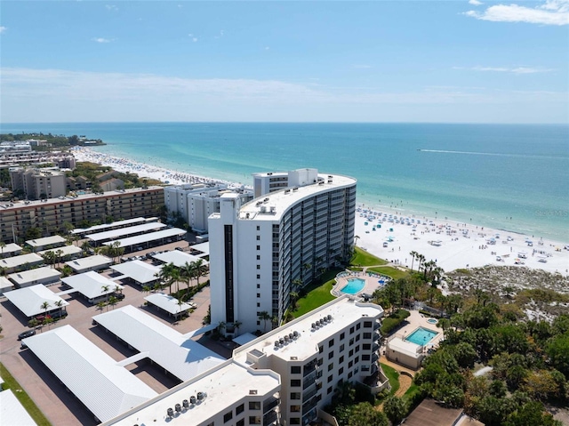 drone / aerial view with a water view and a beach view