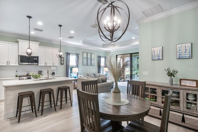 dining area with plenty of natural light, visible vents, and ornamental molding