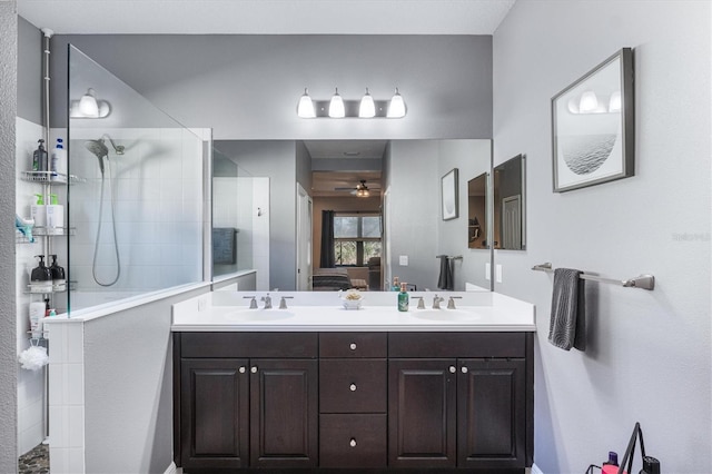 ensuite bathroom with ensuite bathroom, double vanity, a walk in shower, and a sink