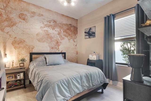 bedroom featuring wood finished floors and baseboards