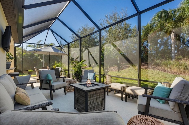 view of patio / terrace with a lanai and an outdoor living space with a fire pit