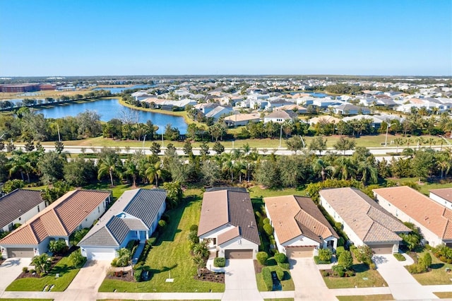 drone / aerial view with a water view and a residential view