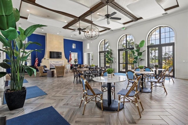 dining room featuring coffered ceiling, visible vents, a towering ceiling, baseboards, and french doors