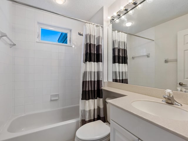 full bathroom with vanity, shower / tub combo, a textured ceiling, and toilet