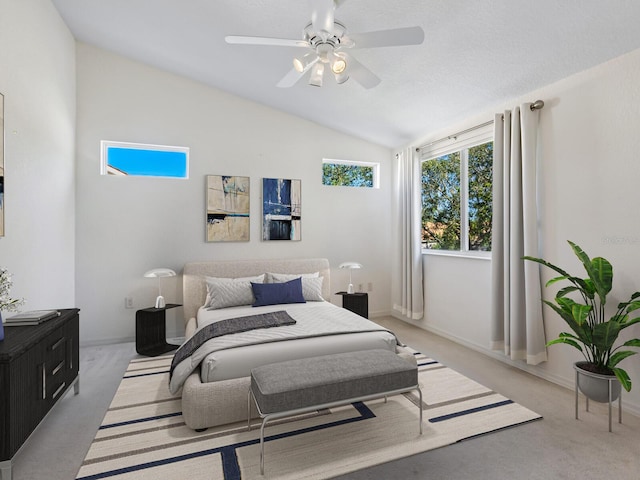 bedroom with ceiling fan, light colored carpet, and vaulted ceiling