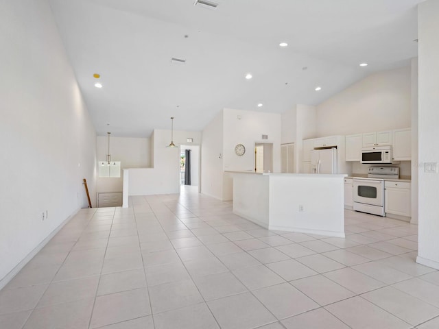 interior space featuring light tile patterned flooring and high vaulted ceiling