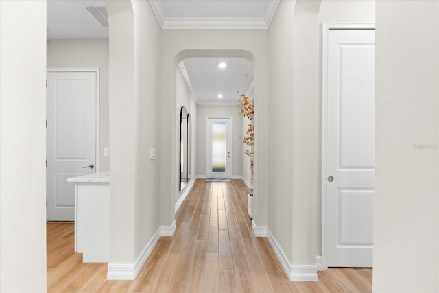 hall featuring crown molding and light hardwood / wood-style flooring