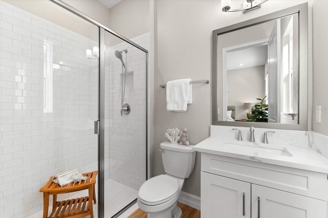 bathroom with hardwood / wood-style flooring, toilet, and walk in shower