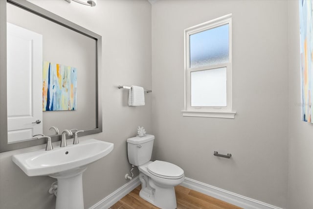 bathroom featuring hardwood / wood-style floors and toilet