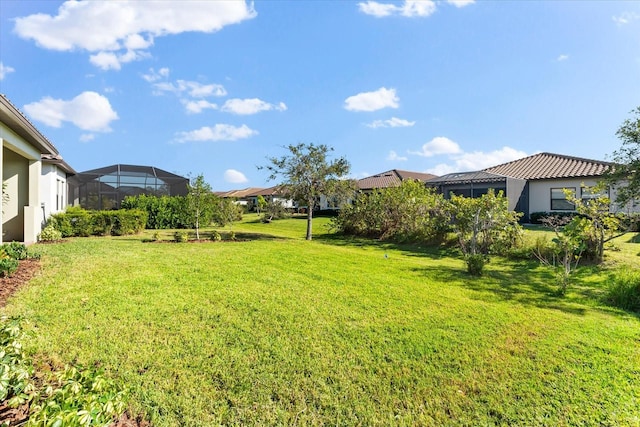 view of yard with glass enclosure