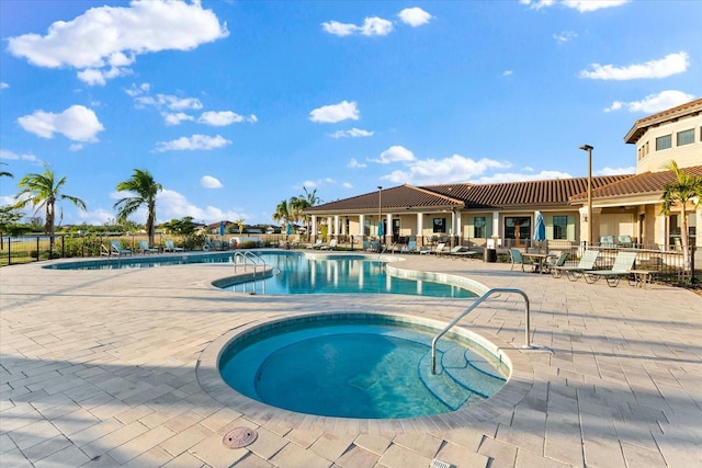 view of pool featuring a community hot tub and a patio