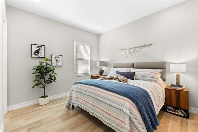 bedroom featuring baseboards and wood finished floors