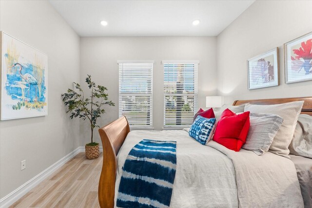 bedroom with recessed lighting, wood finished floors, and baseboards