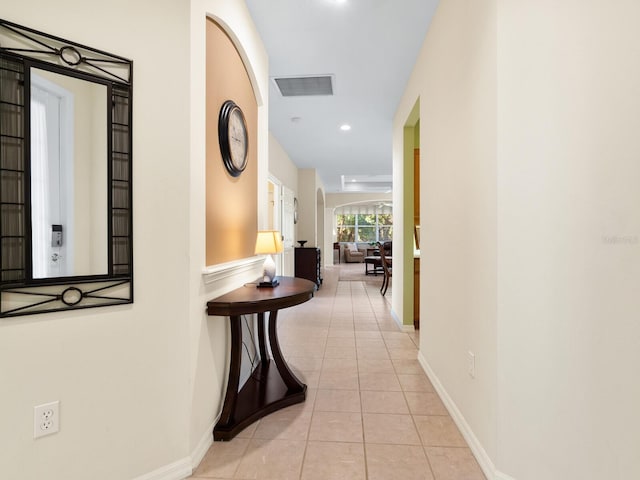 hall featuring light tile patterned flooring