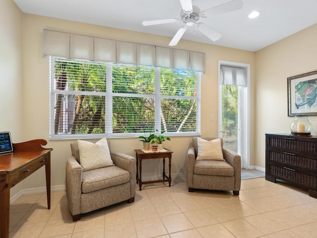 sitting room with plenty of natural light, light tile patterned flooring, and ceiling fan