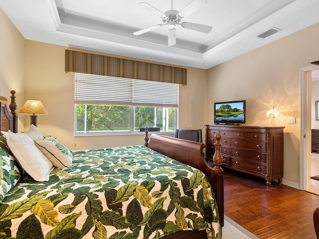 bedroom with dark hardwood / wood-style floors, a raised ceiling, and ceiling fan