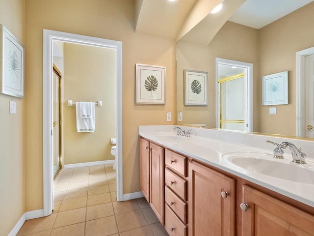 bathroom with tile patterned floors, toilet, vanity, and walk in shower