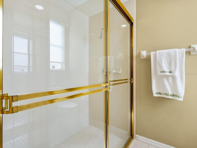 bathroom featuring tile patterned flooring and a shower with shower door