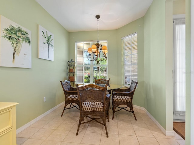 tiled dining area with a chandelier