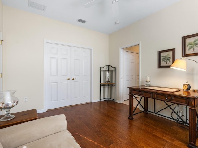 living area with ceiling fan and dark wood-type flooring