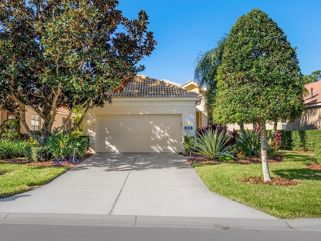 view of front of house featuring a garage and a front lawn