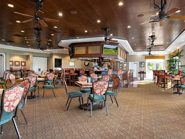 dining area with carpet and ornamental molding