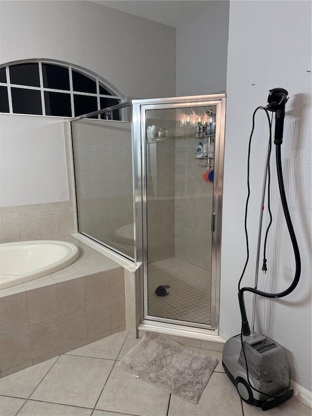 bathroom with tile patterned floors and separate shower and tub