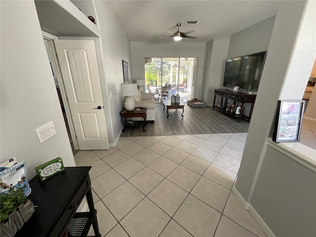 living room featuring ceiling fan and light hardwood / wood-style floors