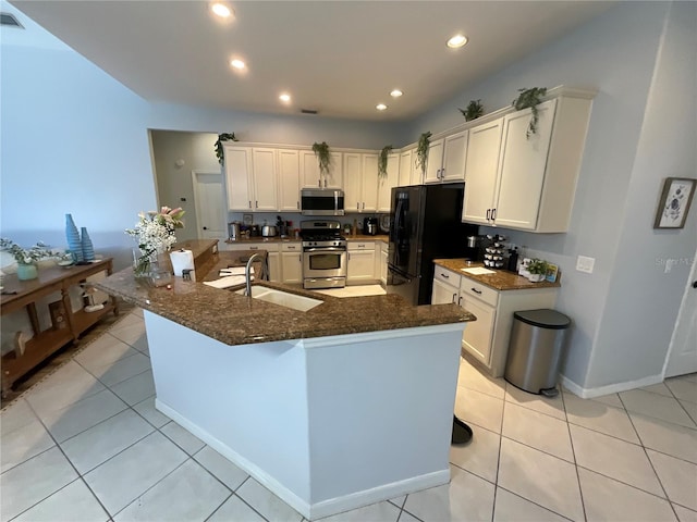 kitchen with sink, light tile patterned flooring, and appliances with stainless steel finishes