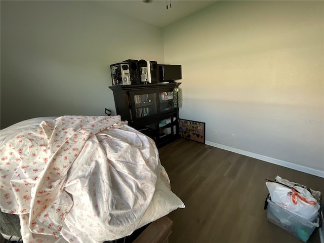 bedroom with dark wood-type flooring