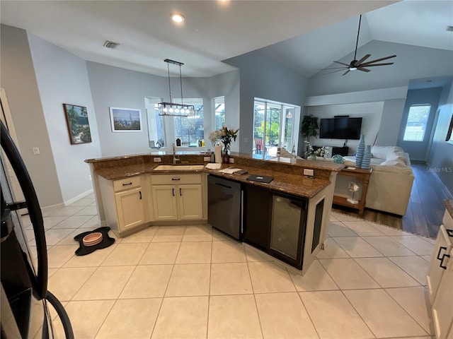 kitchen featuring white cabinetry, dishwasher, sink, dark stone counters, and decorative light fixtures